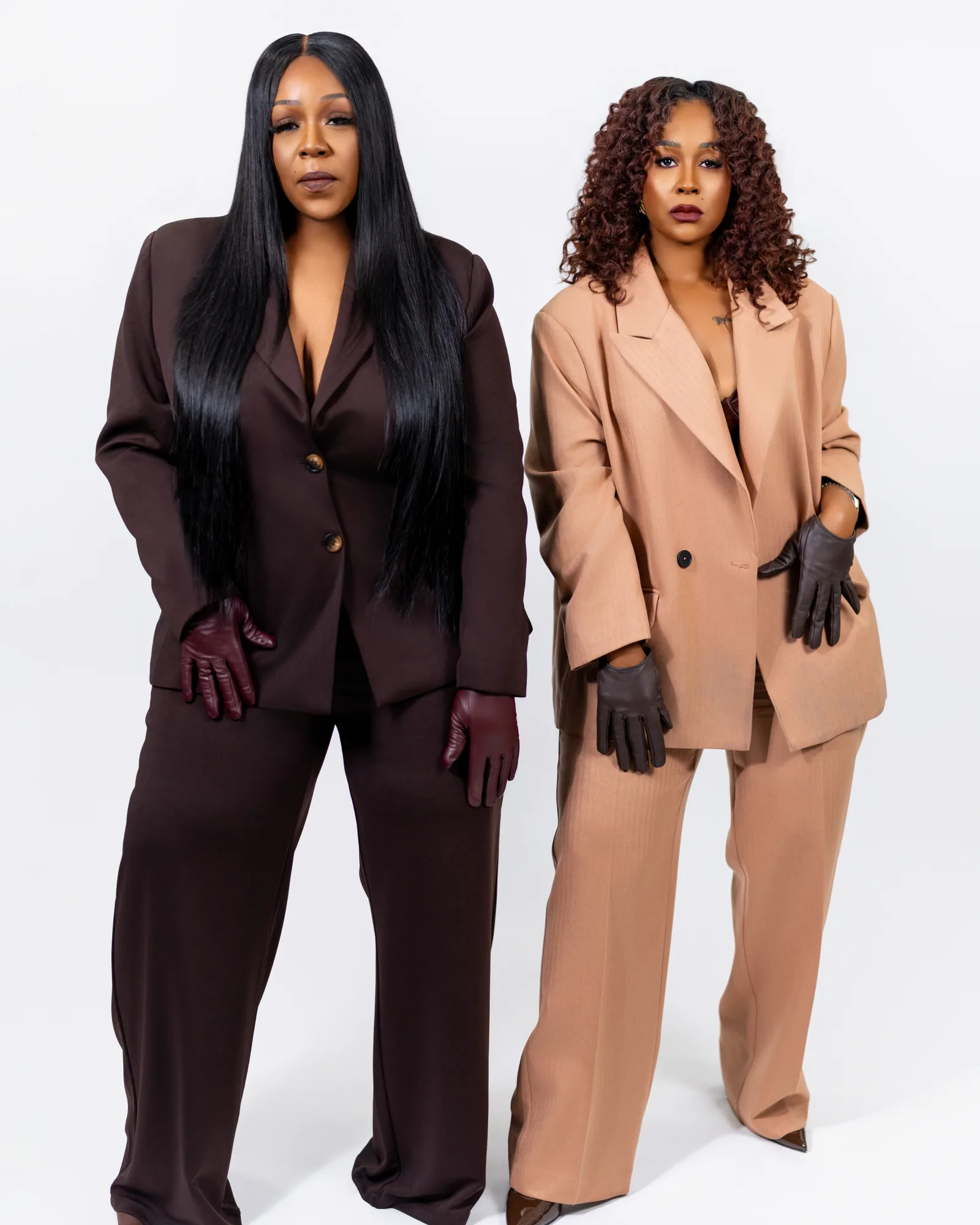 Two fashion subjects photographed on a plain studio background before compositing