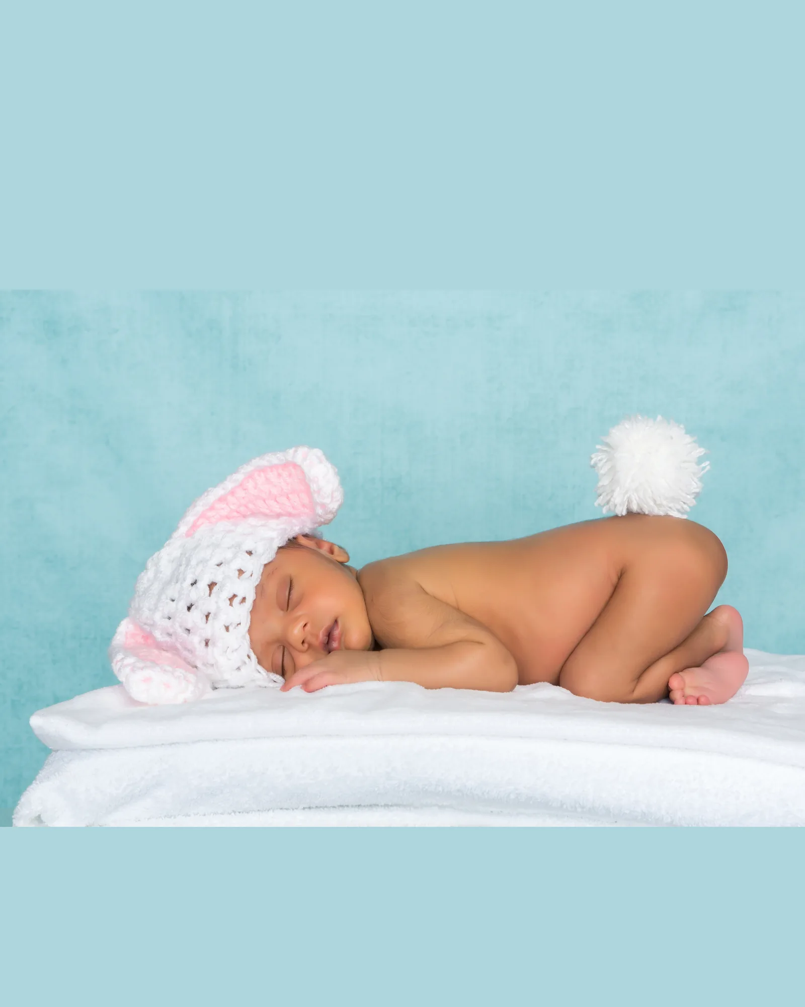 Newborn portrait on a simple blue studio background before compositing